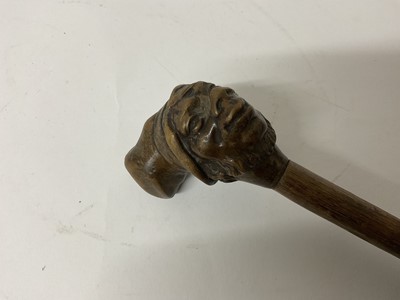 Lot 283 - 19th century novelty carved wooden walking stick with stylised head knop, 79cm long