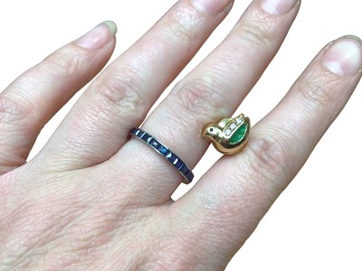 Lot 56 - Platinum and blue sapphire eternity ring and a gold (750) enamel and paste set novelty pin in the form of a duck (2)