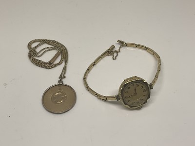 Lot 1087 - 1940s continental 14ct gold wristwatch on yellow metal expandable bracelet together with a yellow metal pendant on chain (2)