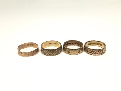 Lot 1109 - Four 9ct gold wedding rings all with engraved decoration