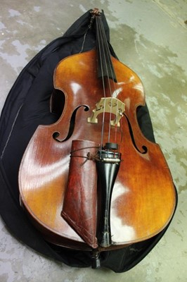 Lot 2235 - Early 20th century double bass by Hawkes, in soft case together with a cased German bow