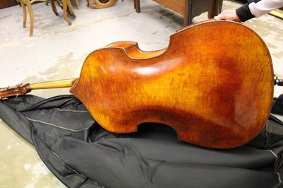 Lot 2235 - Early 20th century double bass by Hawkes, in soft case together with a cased German bow