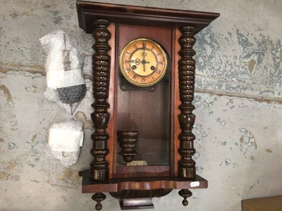 Lot 770 - A wooden cased wall clock with pendulum and key