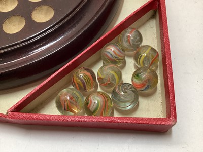 Lot 2414 - Vintage solitaire board with 33 coloured lattice twist glass marbles, in in original red card box