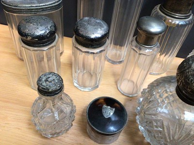 Lot 96 - Collection of mostly silver topped glass vanity jars and perfume bottles