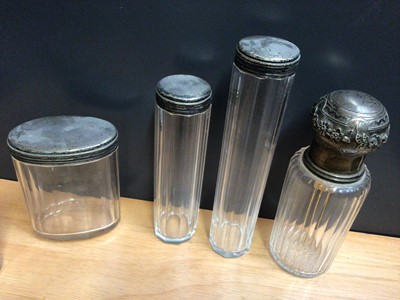 Lot 96 - Collection of mostly silver topped glass vanity jars and perfume bottles