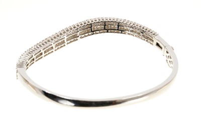 Lot 634 - Diamond bangle with baguette cut and brilliant cut diamonds in 18ct white gold. Estimated total diamond weight approximately 3.53cts