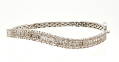 Lot 634 - Diamond bangle with baguette cut and brilliant cut diamonds in 18ct white gold. Estimated total diamond weight approximately 3.53cts