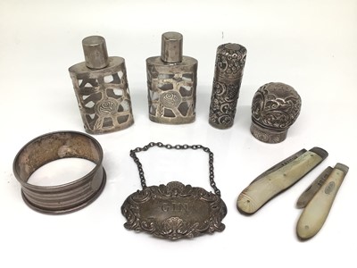 Lot 1135 - Two silver and mother of pearl fruit knives, silver gin label, silver perfume bottles, silver napkin ring and a silver lid