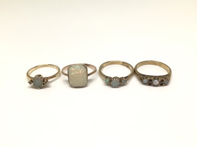 Lot 1148 - Four 9ct gold opal rings