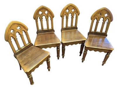 Lot 1535 - Set of four gothic brown oak hall chairs