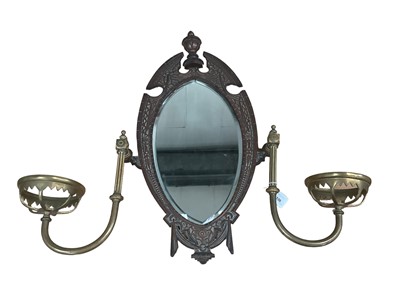 Lot 1530 - Victorian Gothic brass wall mirror with two candle holders.