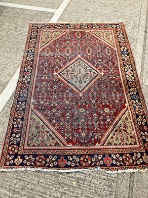 Lot 1512 - Eastern rug with central medallion on red and blue ground, 203cm x 130cm