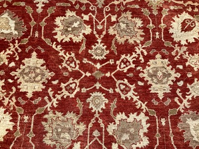 Lot 1516 - Good quality wool rug on red and cream ground, 288cm x 247cm