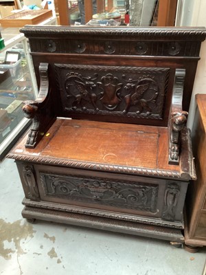 Lot 1517 - Late Victorian heavily carved oak settle with rising lid to seat