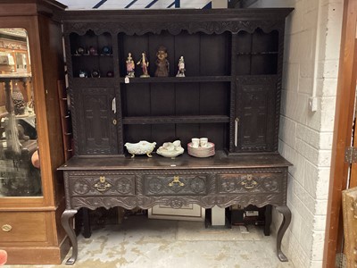 Lot 1518 - Antique carved oak two height dresser with open shelves and two cupboards above, three drawers below on cabriole front legs