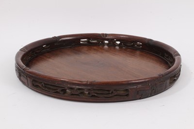 Lot 453 - Early 20th century Chinese carved hardwood circular tray with pierced gallery border