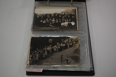 Lot 1503 - Postcards in album, include many real photographic cards of Cambridge villages, Baptising at Isleham Ferry (x6),  Isleham street scenes, parade 1912, Quoit Team 1912, Fairy Play 1920, burial ground...
