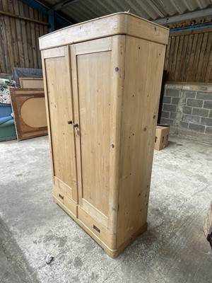 Lot 15 - Pine wardrobe, with hanging space enclosed by two doors, drawer below, 115w x 53d x 201h