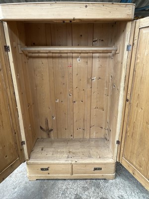 Lot 15 - Pine wardrobe, with hanging space enclosed by two doors, drawer below, 115w x 53d x 201h