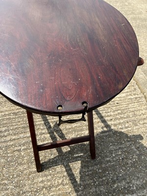 Lot 63 - Edwardian oval mahogany two handled tray with shaped edge, on associated folding stand, tray 77cm x 57cm