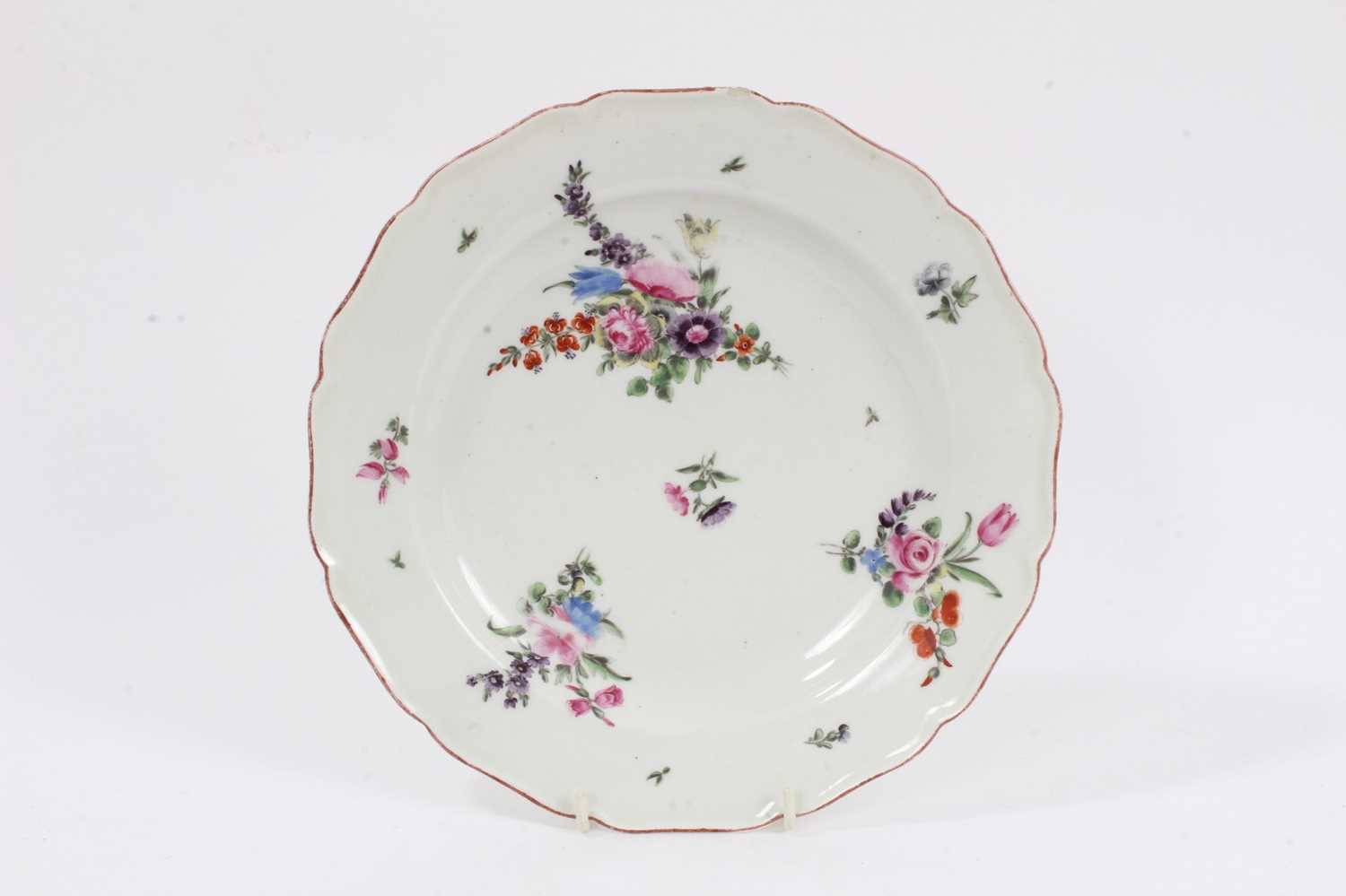 Lot 231 - An 18th century Chelsea porcelain plate, polychrome painted with floral sprays, with iron-red painted scalloped rim, 22.5cm diameter