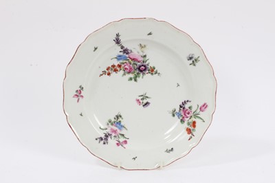 Lot 231 - An 18th century Chelsea porcelain plate, polychrome painted with floral sprays, with iron-red painted scalloped rim, 22.5cm diameter