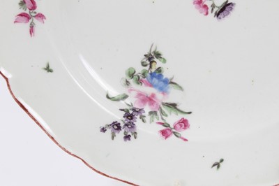 Lot 231 - An 18th century Chelsea porcelain plate, polychrome painted with floral sprays, with iron-red painted scalloped rim, 22.5cm diameter