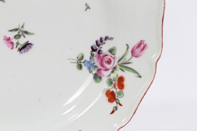 Lot 231 - An 18th century Chelsea porcelain plate, polychrome painted with floral sprays, with iron-red painted scalloped rim, 22.5cm diameter