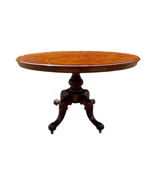 Lot 69 - Victorian burr walnut oval tilt top loo table on turned column and four splayed legs, 120cm x 88cm