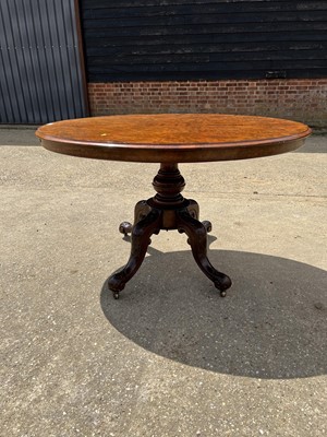 Lot 69 - Victorian burr walnut oval tilt top loo table on turned column and four splayed legs, 120cm x 88cm