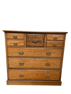 Lot 44 - Edwardian blond oak chest of drawers, with central deep drawer and four short drawers, three long graduated drawers on plinth base, 124w x 53d x 118h
