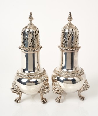 Lot 478 - Pair of 1930s silver sugar casters of baluster form on three lion mask and claw feet