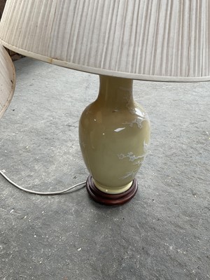 Lot 95 - Pair of oriental style porcelain baluster table lamps, yellow glazed, with shades