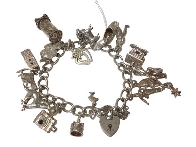 Lot 76 - Silver charm bracelet with various silver and white metal novelty charms