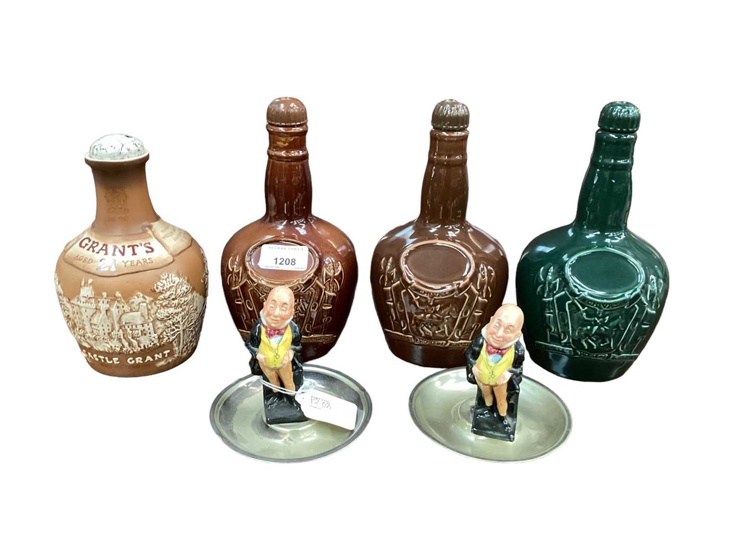 Lot 43 - Two Royal Doulton Kingsware whisky flagons, together with Spode and another Doulton whisky flagon, and a pair of Doulton figural ashtrays