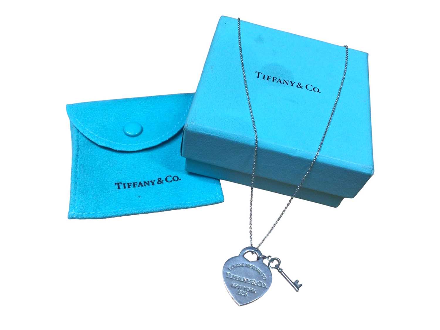 Lot 188 - Tiffany & Co silver 'Return to Tiffany' heart tag with key pendant on chain, with pouch and box