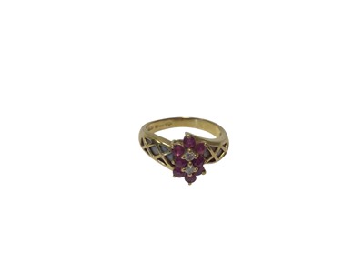 Lot 79 - 18ct gold ruby and diamond double flower head cluster ring