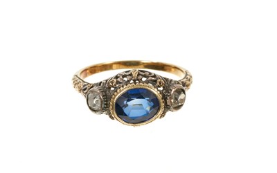 Lot 638 - Antique French gold blue sapphire and diamond three stone ring in a pierced foliate setting