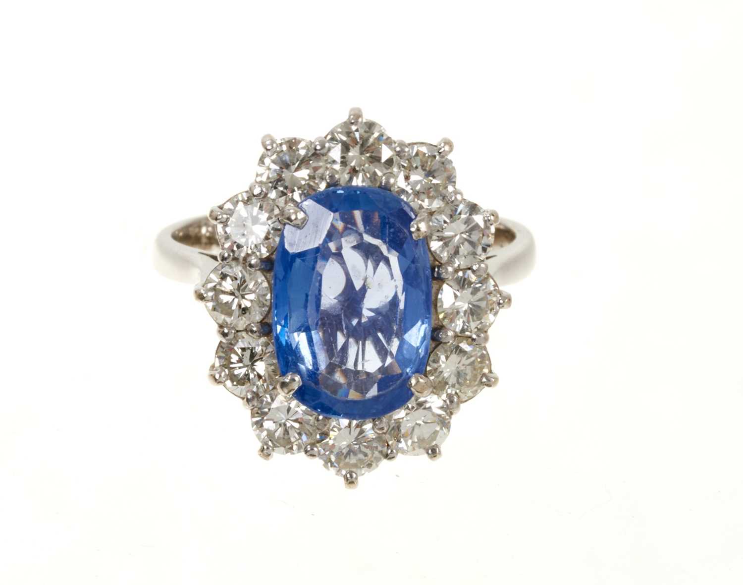 Lot 637 - 18ct white gold sapphire and diamond cluster ring