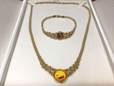 Lot 147 - Yellow metal (stamped 14k) amber pendant rope twist necklace and bracelet set