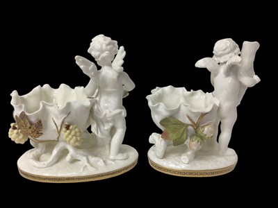 Lot 283 - Two similar late 19th century Moore Bros. porcelain sweetmeat baskets decorated with cherubs and gilt ornament