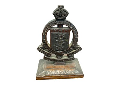 Lot 652 - 1920s/30s carved hardwood Royal Army Ordnance Corps Officers desk ornament with carved double sided regimental badge on floral carved base 29cm high