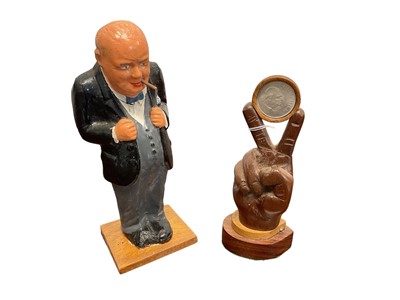 Lot 668 - Second World War plaster figure of Winston Churchill 24.5cm  and old novelty carved wood Churchill hand in Victory V pose 19cm (2)