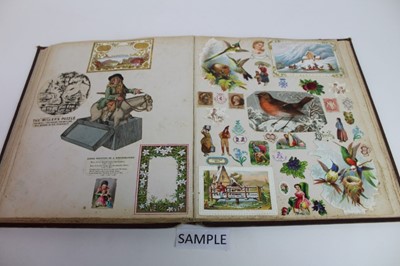 Lot 1562 - Victorian scrap book containing crests, drawings, paper lace valentines and greeting cards, political and other cartoons, stamps, engravings, fashoin, dried folage,  personalities, scraps flowers,...