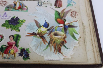 Lot 1562 - Victorian scrap book containing crests, drawings, paper lace valentines and greeting cards, political and other cartoons, stamps, engravings, fashoin, dried folage,  personalities, scraps flowers,...