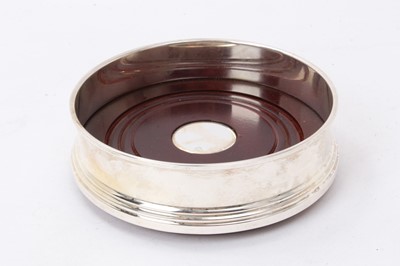 Lot 508 - Contemporary silver wine coaster of plain circular form, with turned wooden base