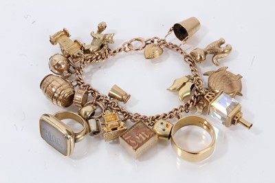 Lot 692 - 9ct gold charm bracelet with numerous gold charms to include an 18ct gold wedding ring and a regency gilt metal seal