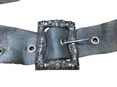 Lot 128 - Eastern white metal mesh belt with figure decoration to the buckle, 72cm long