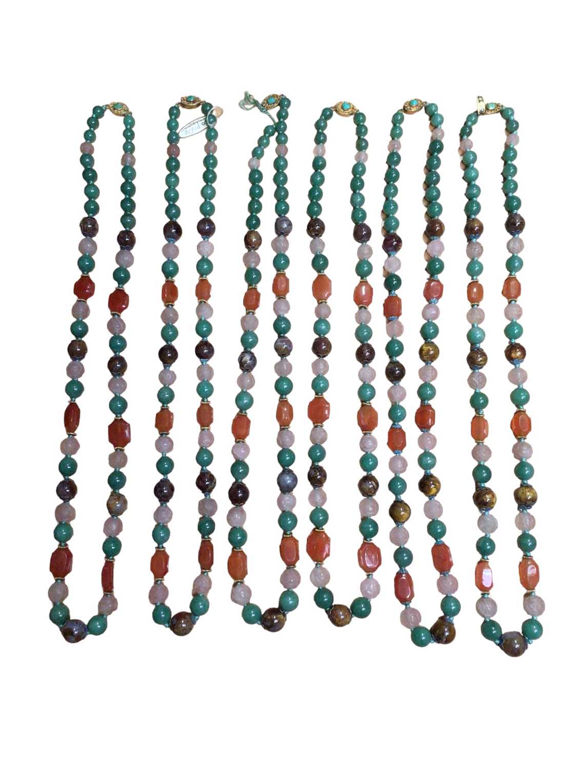 Lot 130 - Six Chinese green hard stone, carnelian and carved rose quartz bead necklaces with silver gilt claps set with a turquoise stone